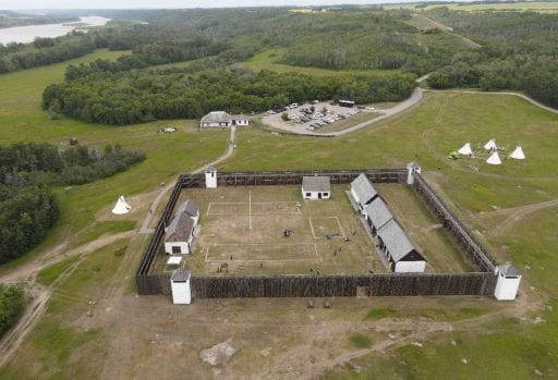 Photo of Fort Carlton Provincial Historic Park. Image is taken from the air above and shows the full scale of the fort including walls and buildings. 
