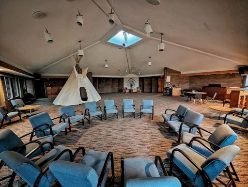 Inside view of a large room with a tepee and circle of chairs at The Carter House in Saskatoon where 17 new inpatient addictions treatment spaces are now operational. 
